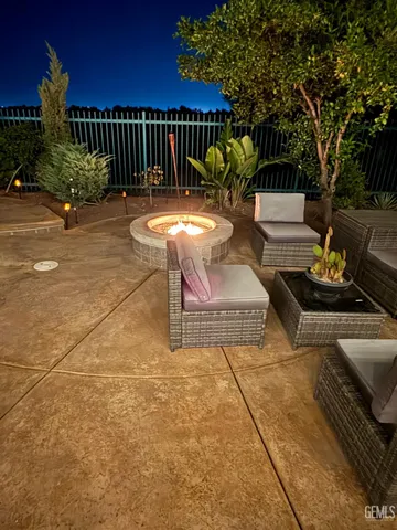 a view of a patio with couches table and chairs and potted plants