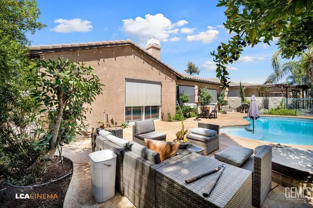 a view of a patio with couches chairs and a potted plant