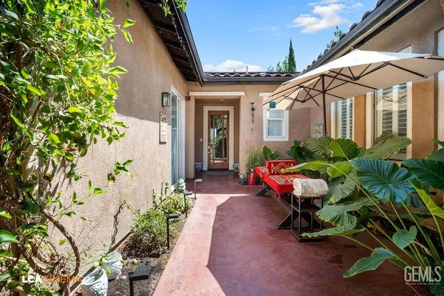 a front view of a house with outdoor seating
