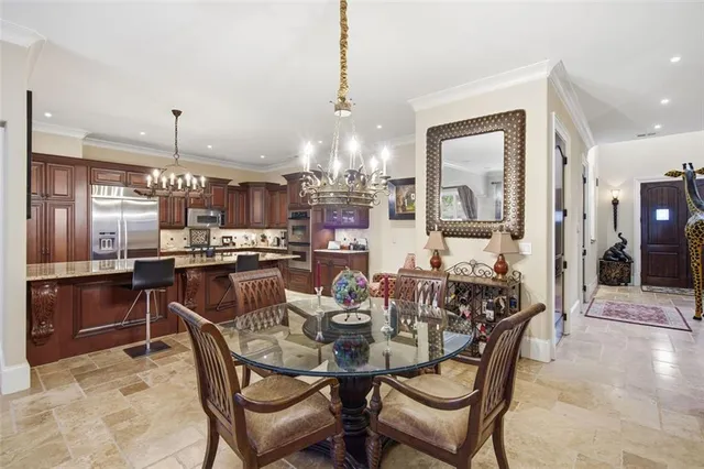 a dining area with furniture and chandelier