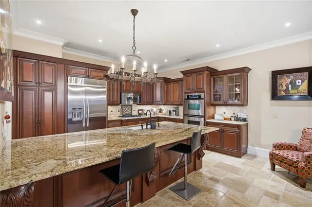 a kitchen with stainless steel appliances granite countertop a stove and refrigerator