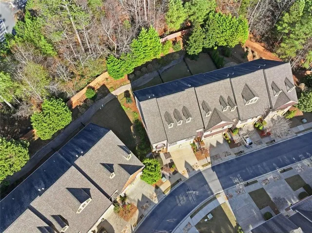 an aerial view of a house with wooden fence