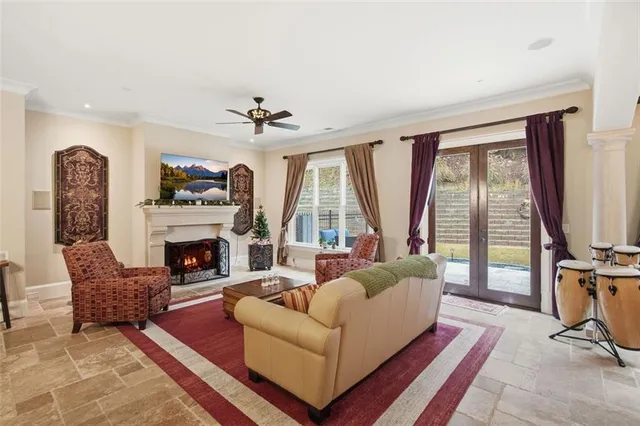 a living room with furniture a large window and a fireplace