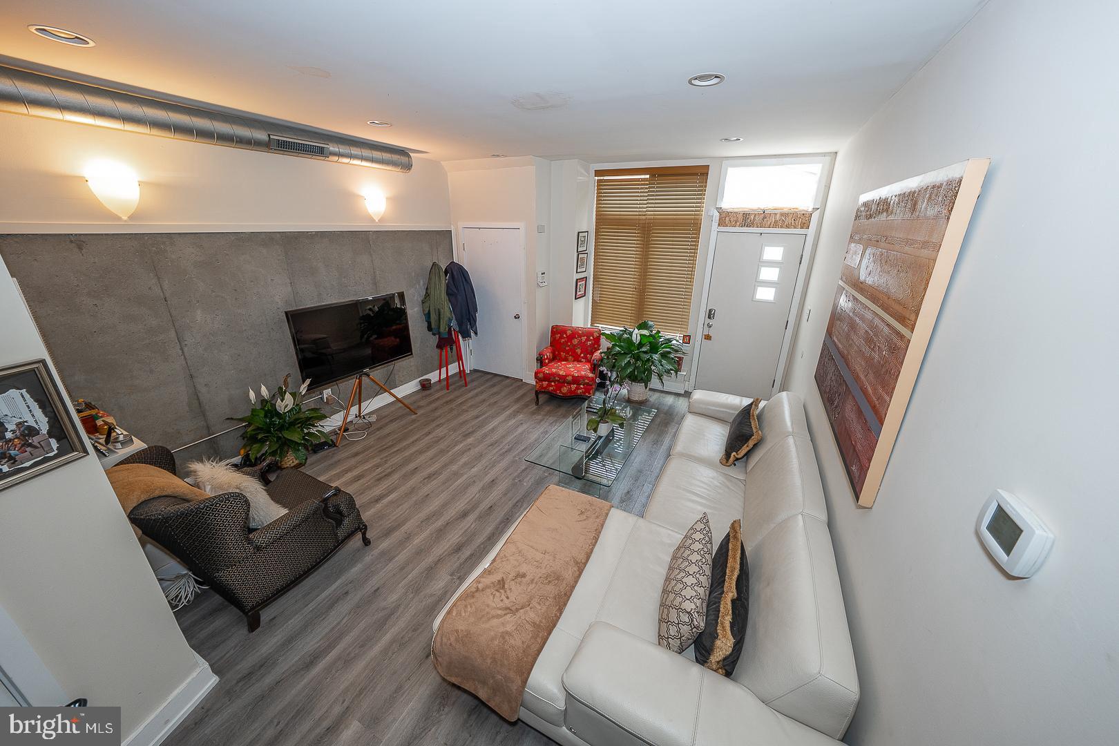 715 Shirley Street, Unit A Philadelphia, PA 19130 - Photo 6 of 24 a living room with furniture and a flat screen tv