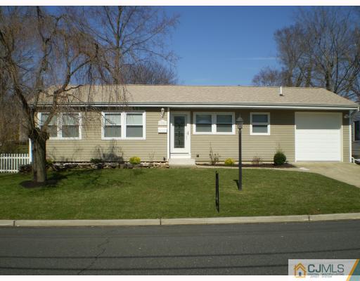 33 Brandeis Road Old Bridge, NJ 08859 - Photo 1 of 10 a view of a white house next to a yard