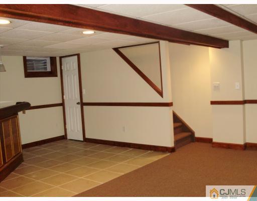 33 Brandeis Road Old Bridge, NJ 08859 - Photo 9 of 10 a view of a big room with wooden floor and electronic appliances