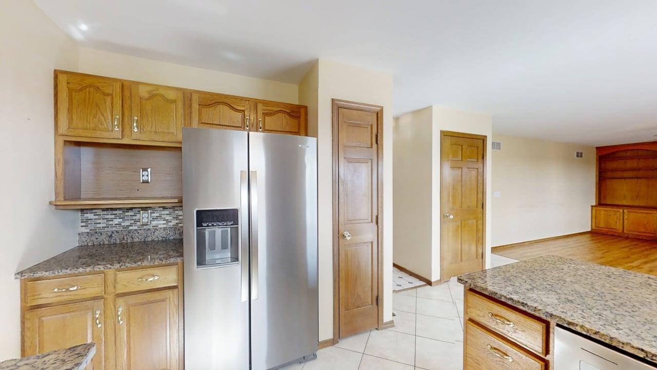 4511 Copper Ridge Road Champaign, IL 61822 - Photo 13 of 55 a kitchen with stainless steel appliances granite countertop a refrigerator and a sink