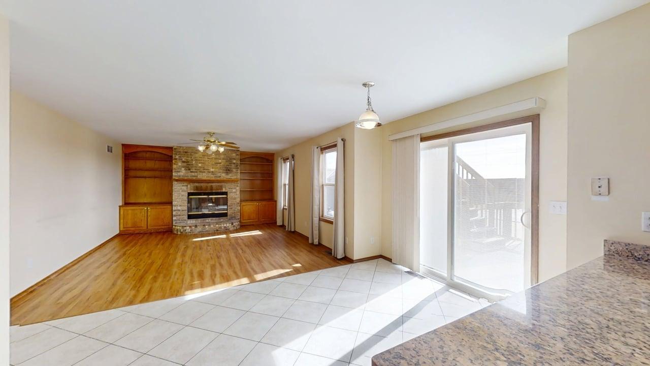 4511 Copper Ridge Road Champaign, IL 61822 - Photo 15 of 55 a view of an empty room with a fireplace and a window