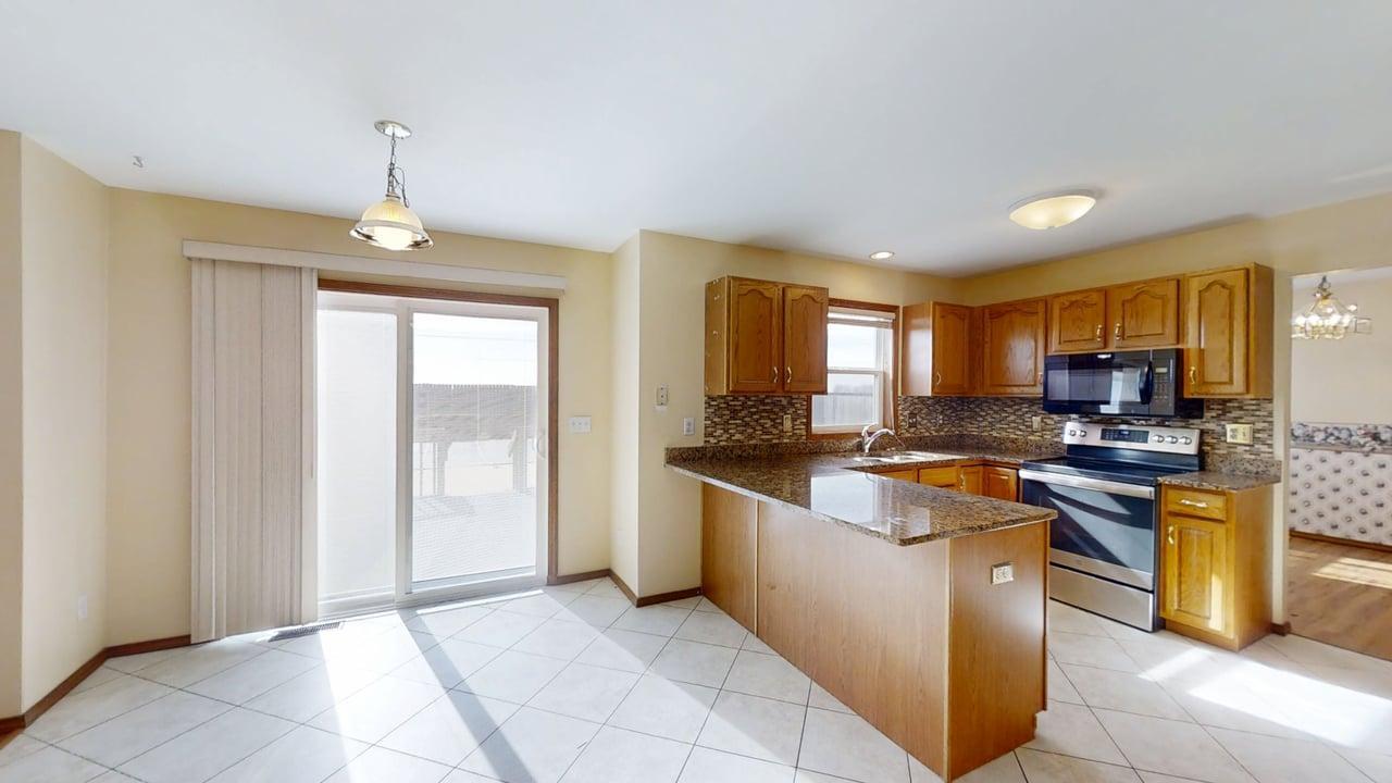 4511 Copper Ridge Road Champaign, IL 61822 - Photo 16 of 55 a kitchen with stainless steel appliances granite countertop a stove top oven a sink a counter space and cabinets