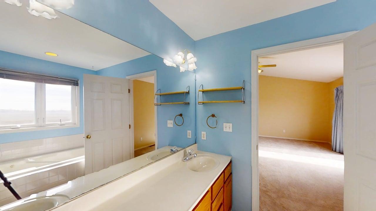 4511 Copper Ridge Road Champaign, IL 61822 - Photo 29 of 55 a en suite bathroom with a sink and a mirror