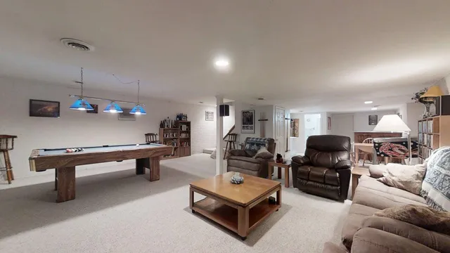 a living room with furniture a rug and a projector