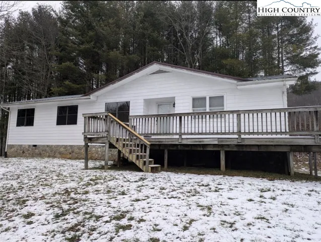 a view of a house with a wooden deck