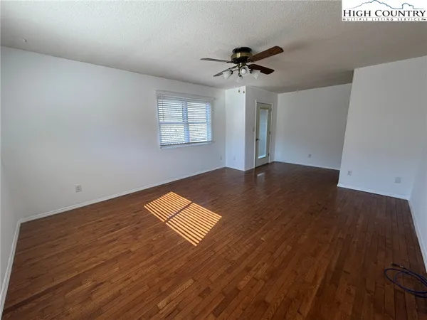 a view of a room with a ceiling fan