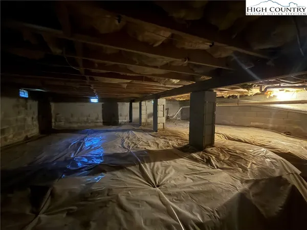 a bed sitting in a bedroom next to a car