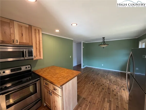 a kitchen with kitchen island a stove and a microwave