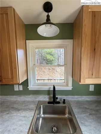 a kitchen with stainless steel appliances a sink and a window