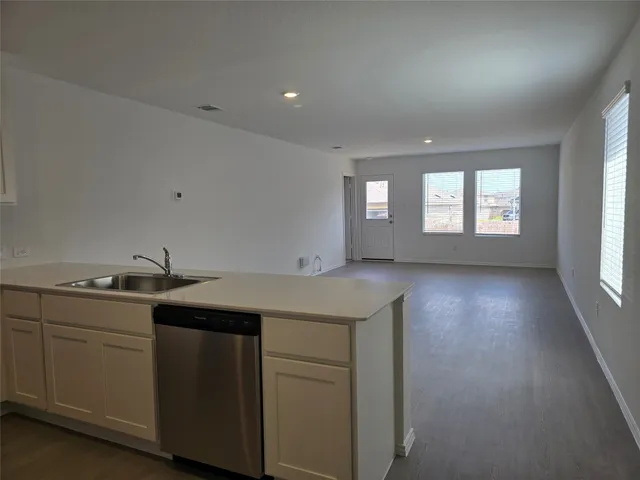 a kitchen with sink and cabinets