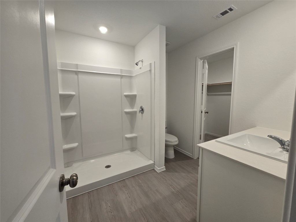 1036 Soapstone Pass Maxwell, TX 78656 - Photo 8 of 15 a bathroom with a granite countertop sink a toilet and shower