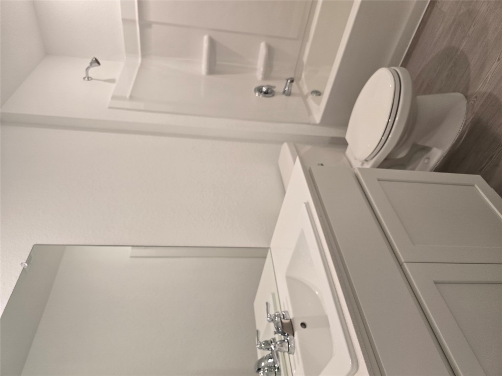 1036 Soapstone Pass Maxwell, TX 78656 - Photo 10 of 15 a bathroom with a sink a toilet and a bathtub