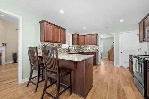 a front view of a house with a yard and trees