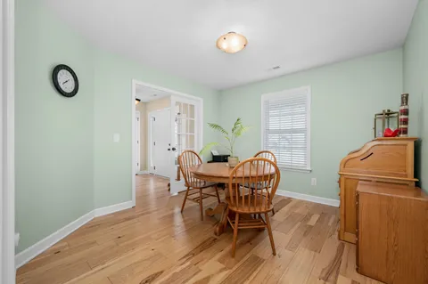 a front view of a house with a yard and trees