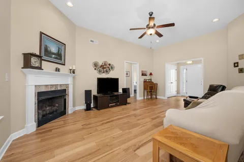 a front view of a house with a yard and trees