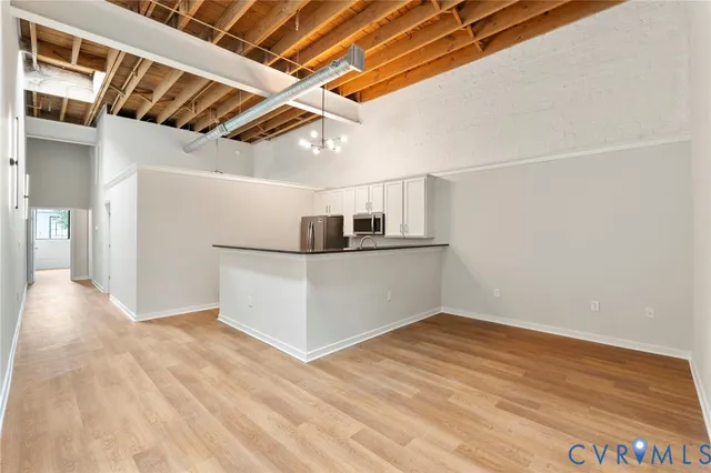 a view of empty room with wooden floor