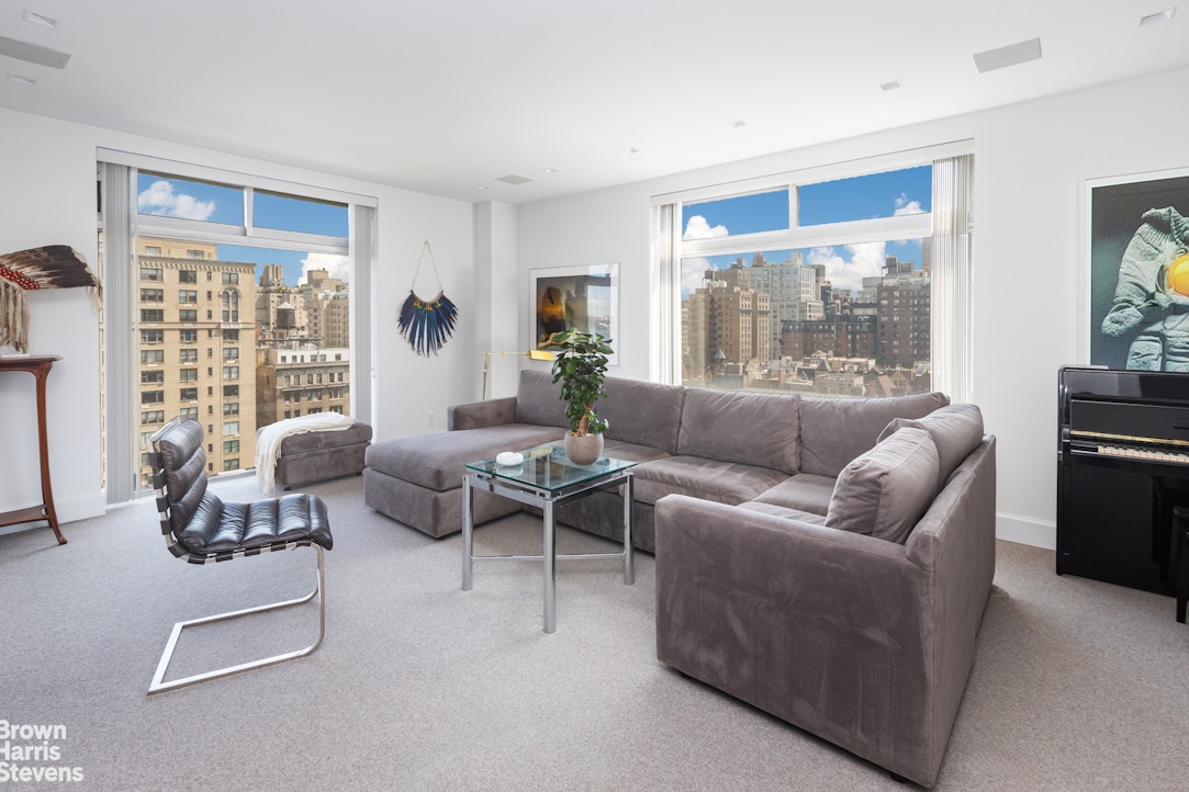a living room with furniture and a large window