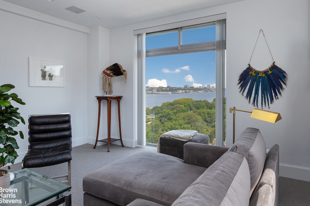 37 Riverside Drive, Unit 12B Manhattan, NY 10023 - Photo 2 of 20 a living room with furniture and a floor to ceiling window
