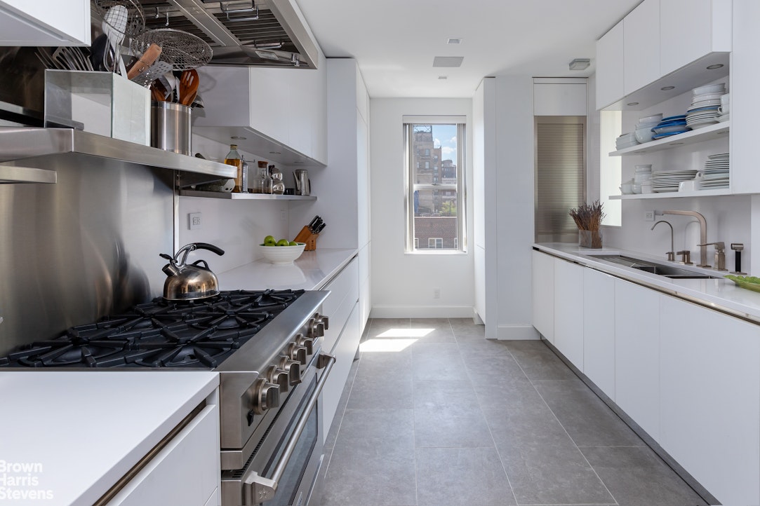 37 Riverside Drive, Unit 12B Manhattan, NY 10023 - Photo 7 of 20 a kitchen with stainless steel appliances granite countertop a stove and a sink