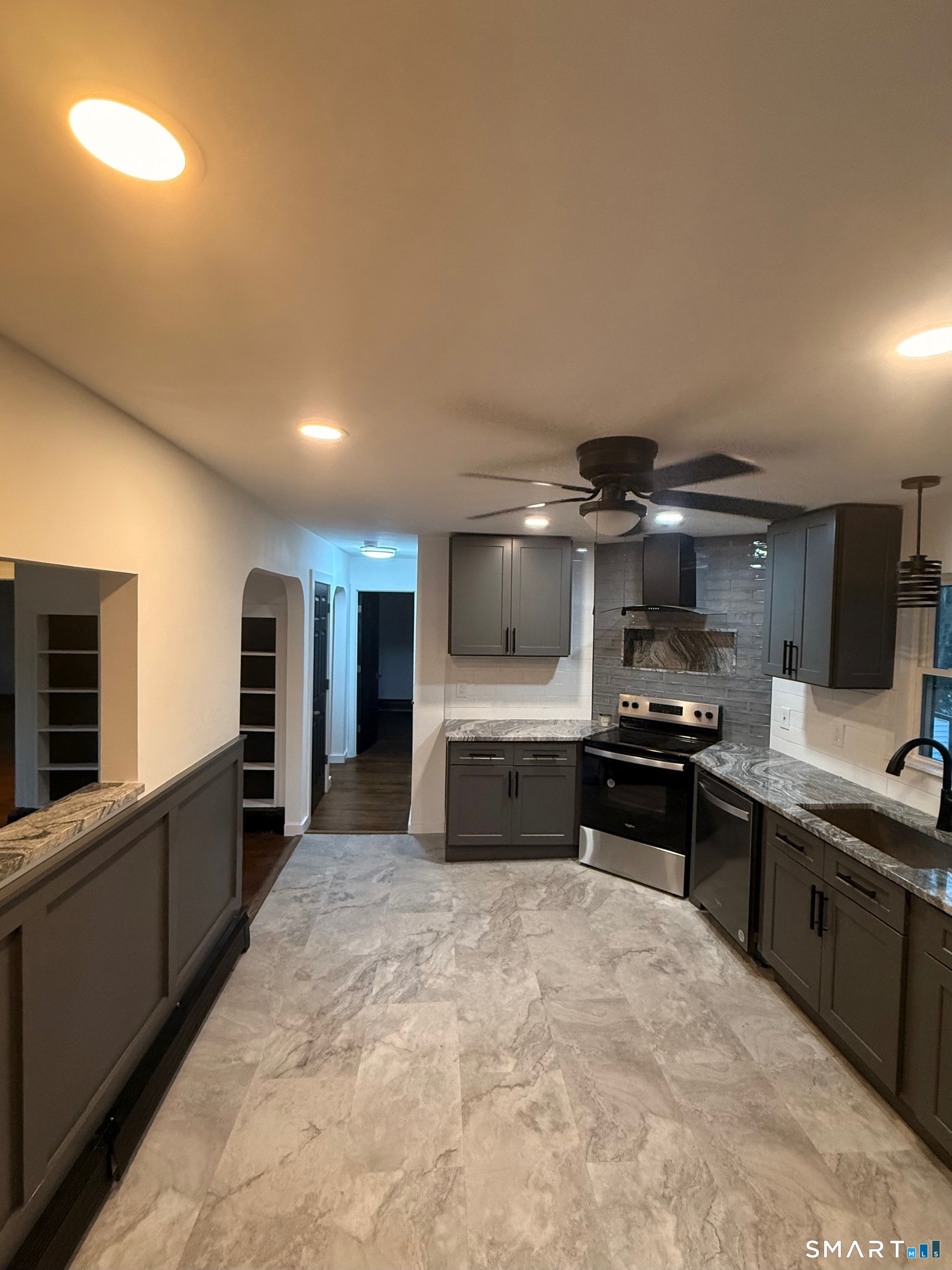 8 Eddy Road Montville, CT 06370 - Photo 2 of 13 a large kitchen with stainless steel appliances a stove a sink dishwasher a microwave oven with cabinets and wooden floor