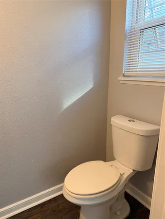 a white toilet sitting next to a white sink