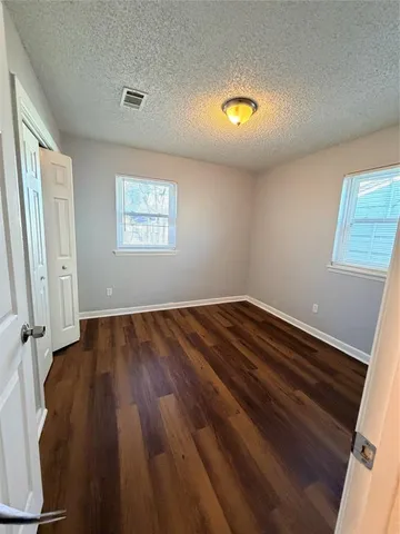 a view of room with wooden floor and window