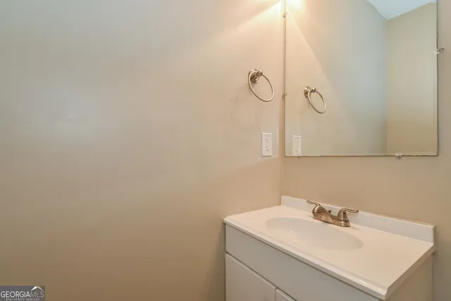 a bathroom with a sink and mirror