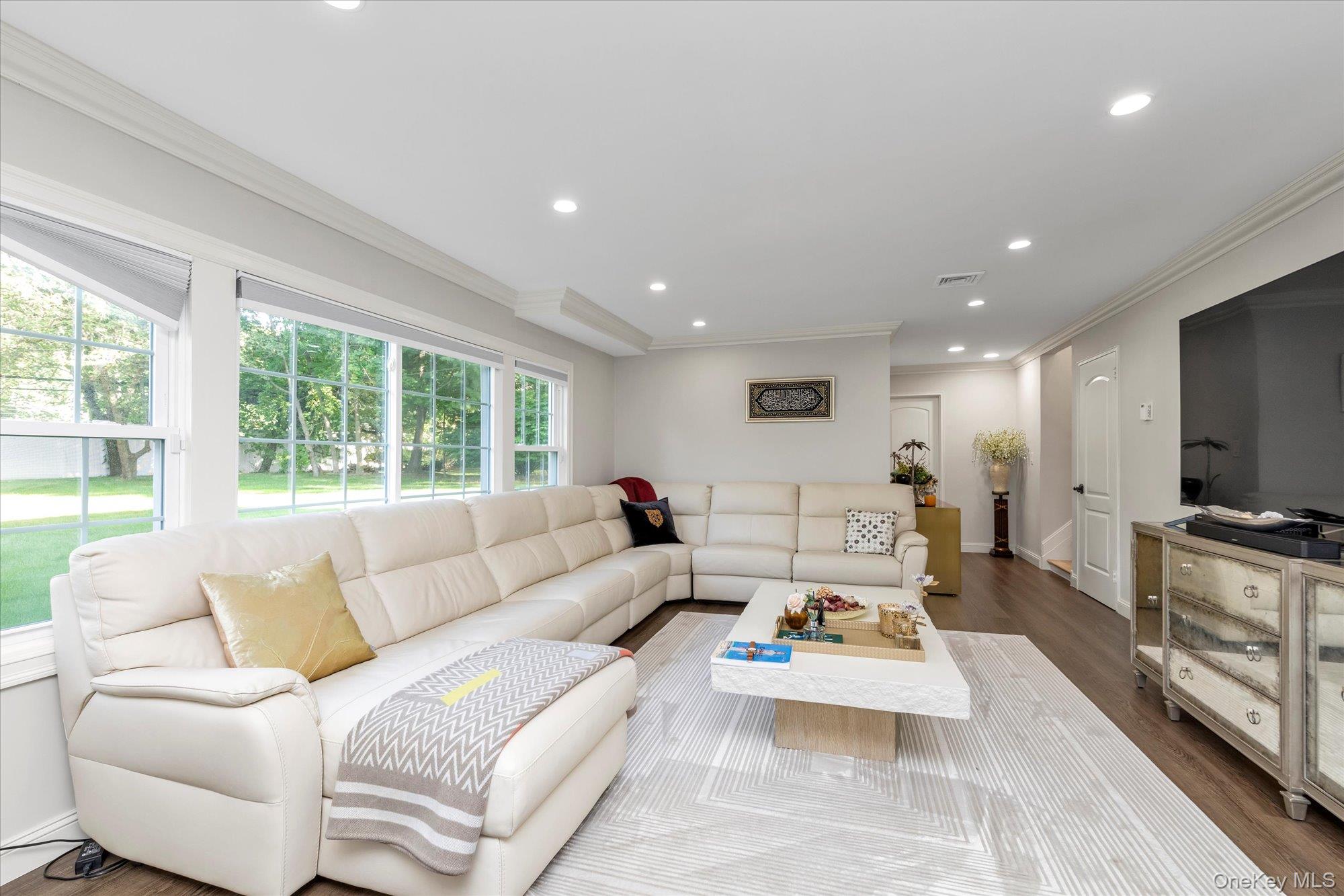 47 Pinewood Road Roslyn, NY 11576 - Photo 11 of 22 a living room with furniture and a flat screen tv