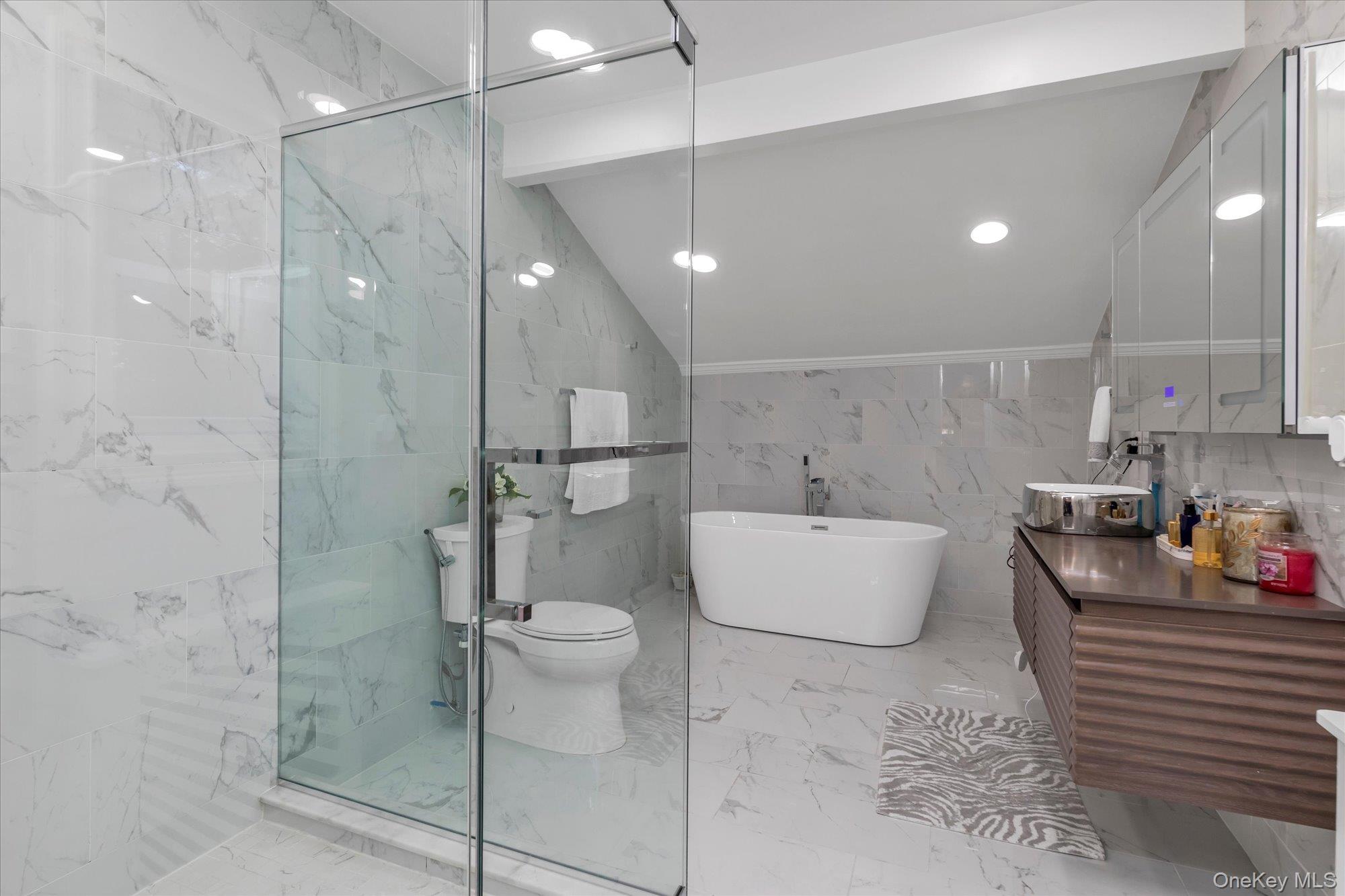 47 Pinewood Road Roslyn, NY 11576 - Photo 13 of 22 a bathroom with a bathtub shower sink and toilet