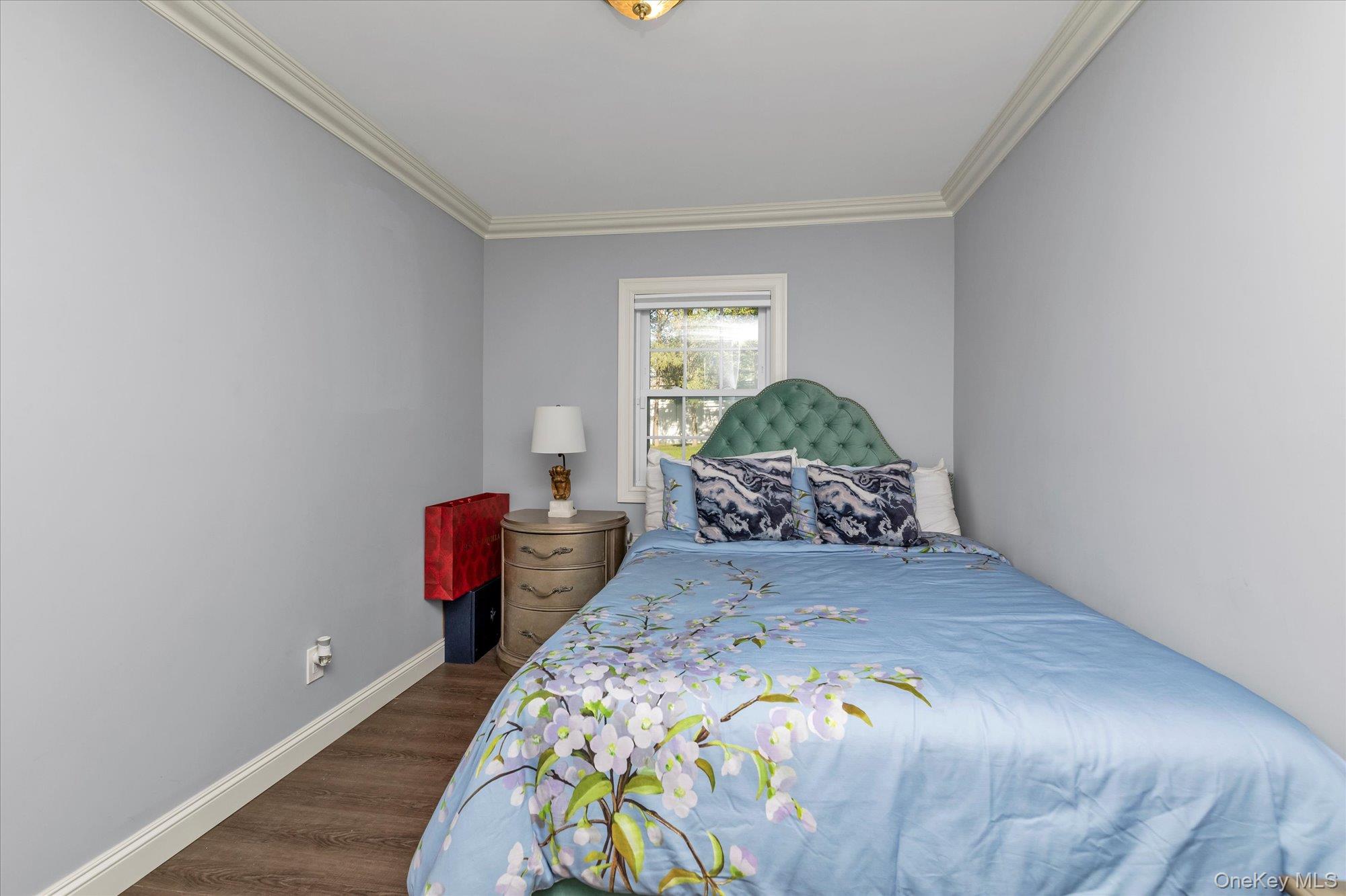 47 Pinewood Road Roslyn, NY 11576 - Photo 16 of 22 a bedroom with a bed and wooden floor