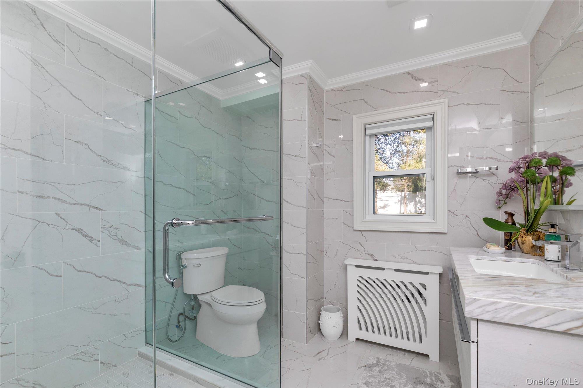 47 Pinewood Road Roslyn, NY 11576 - Photo 17 of 22 a bathroom with a sink a toilet and shower