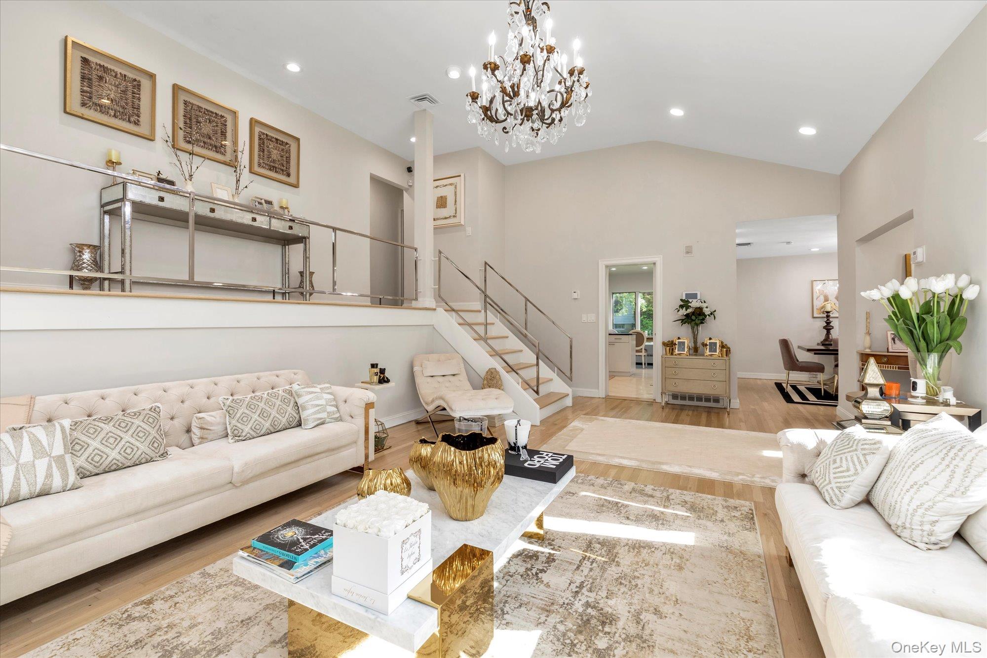 47 Pinewood Road Roslyn, NY 11576 - Photo 4 of 22 a living room with furniture and a chandelier