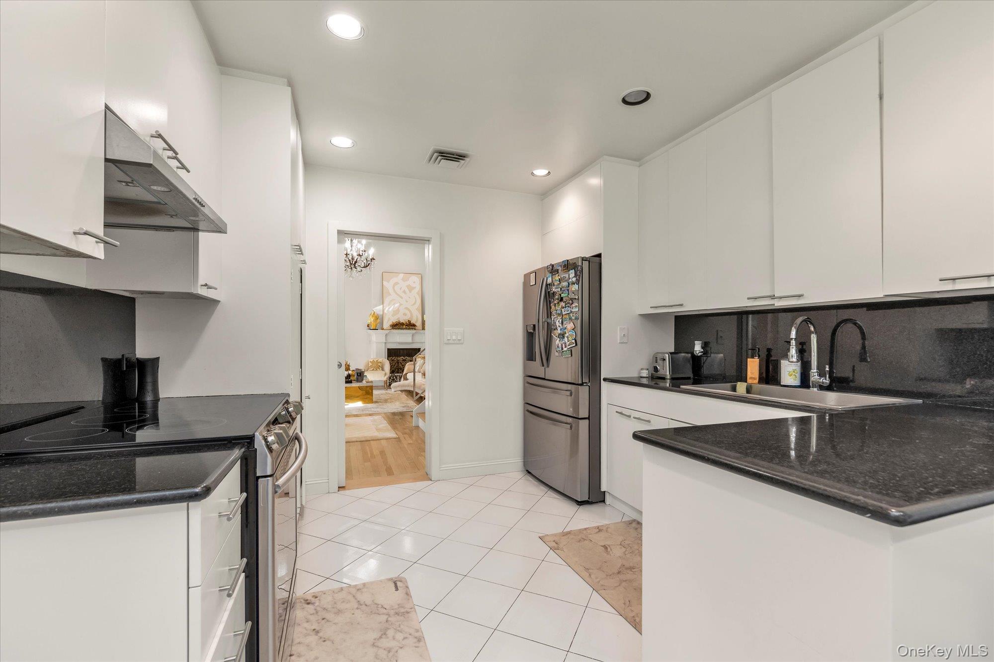 47 Pinewood Road Roslyn, NY 11576 - Photo 6 of 22 a kitchen with stainless steel appliances granite countertop a refrigerator and a stove