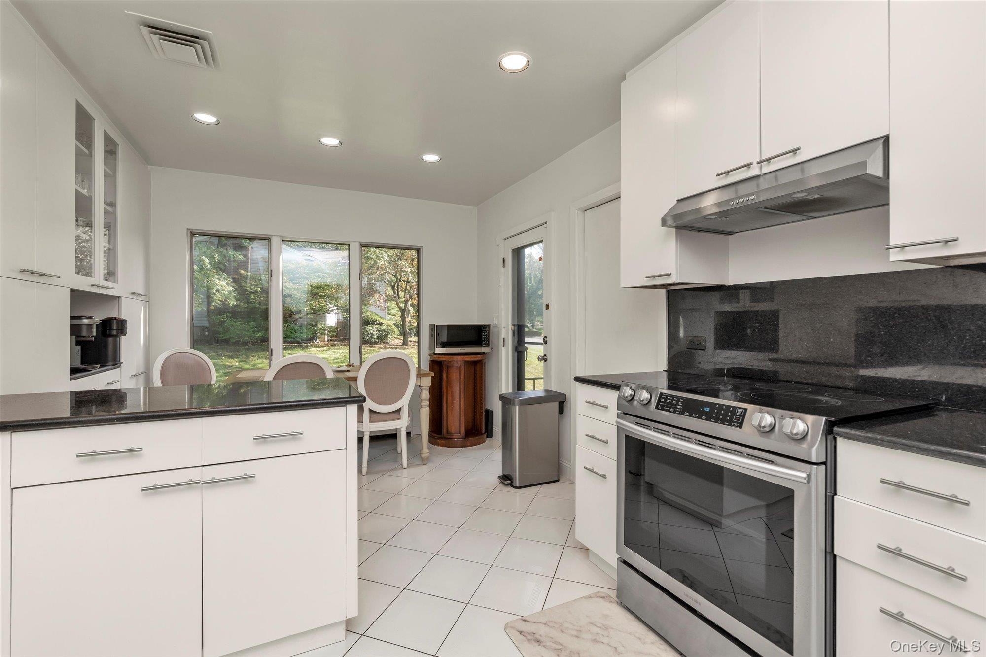 47 Pinewood Road Roslyn, NY 11576 - Photo 8 of 22 a kitchen with appliances cabinets and a counter top space