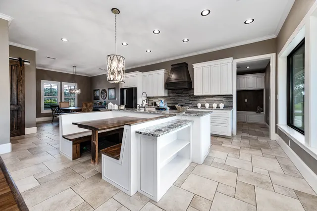 a living room with furniture and large windows