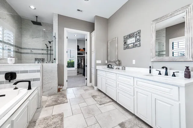 a bathroom with a bathtub and a shower