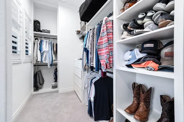 a view of a hallway with wooden floor and stairs