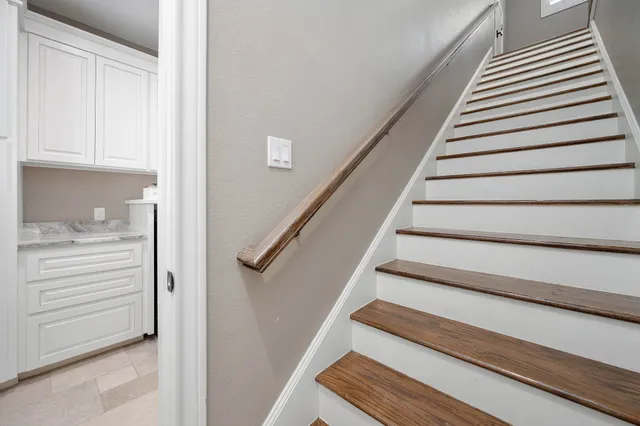 a bedroom with a bed window and a flat screen tv
