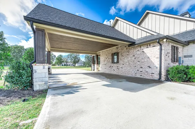 a view of a white house with a swimming pool