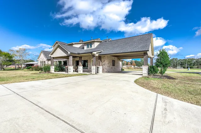 a view of a patio with a table chairs and a small yard