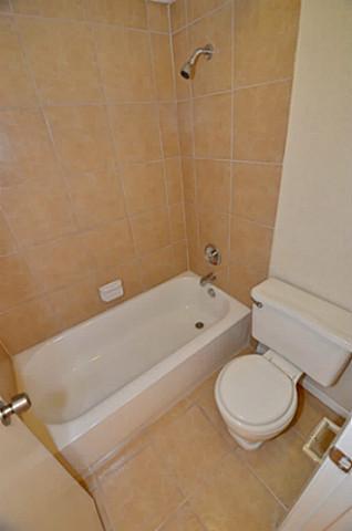 7619 Pebblestone Drive Dallas, TX 75230 - Photo 16 of 21 a bathroom with a toilet and bathtub