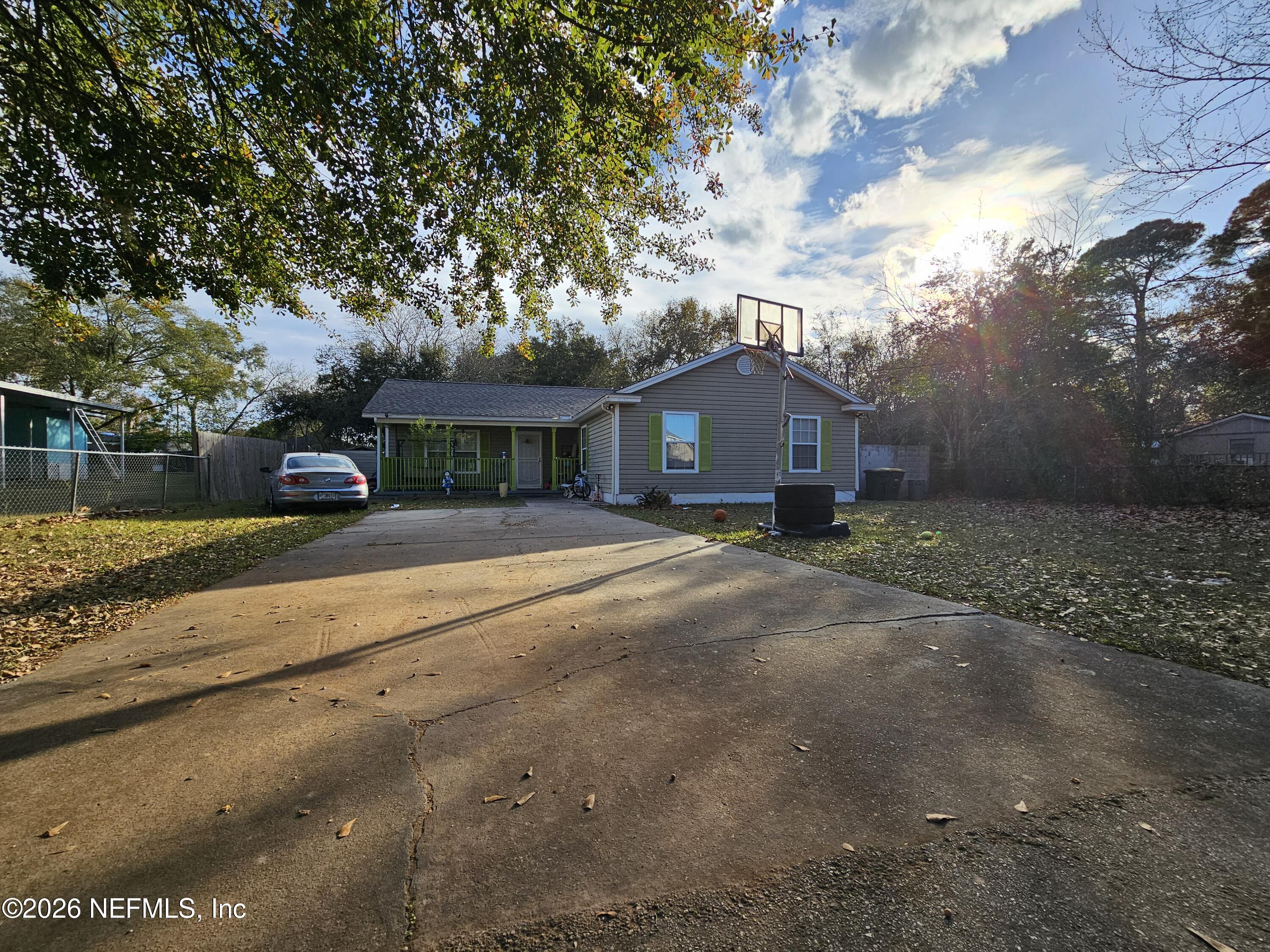 8450 Noroad Jacksonville, FL 32210 - Photo 1 of 14 a front view of a house with a yard and garage