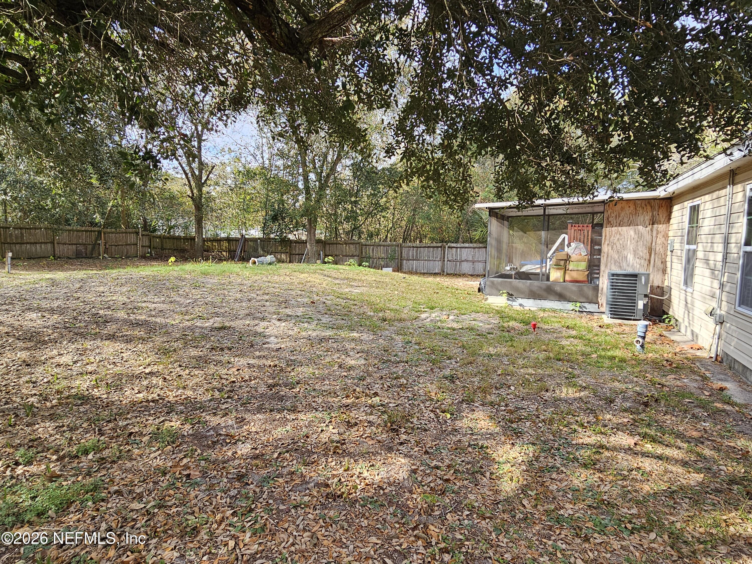 8450 Noroad Jacksonville, FL 32210 - Photo 12 of 14 a backyard of a house with table and chairs